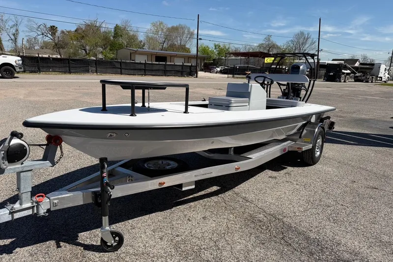Slide: The Image of 2026 Chittum Skiffs 18 Laguna Madre boat on trailer, parked outdoors. - 4