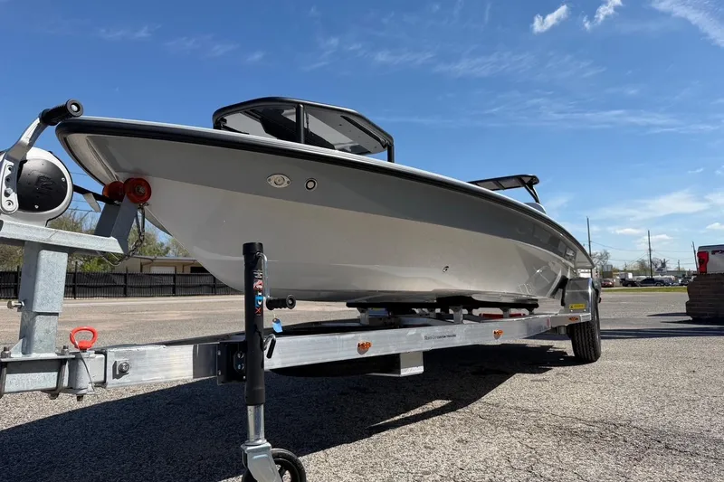 Slide: The Image of 2026 Chittum Skiffs 18 Laguna Madre boat on trailer under clear blue sky. - 6