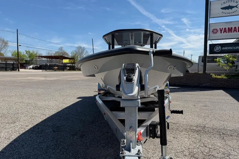 Slide: The Image of 2026 Chittum Skiffs 18 Laguna Madre boat on trailer, parked outdoors under clear sky. - 7