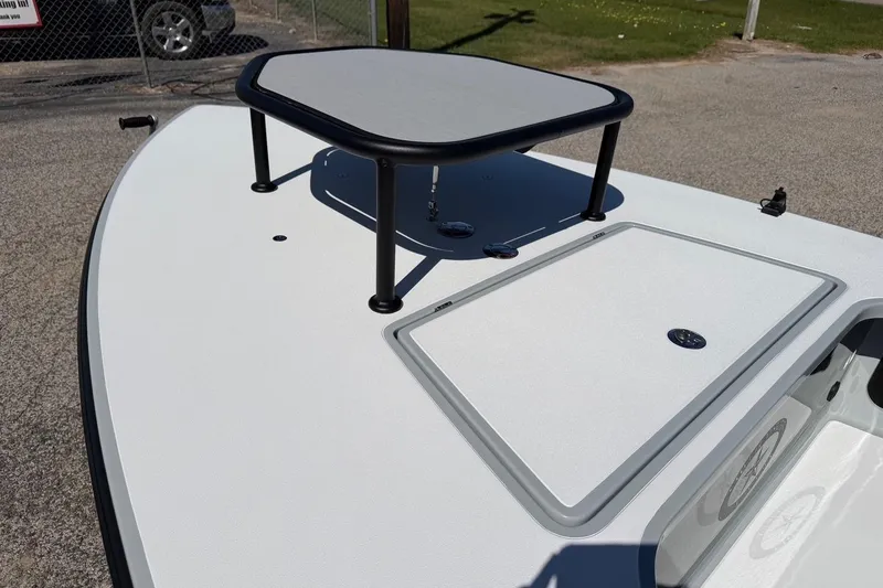 Slide: The Image of 2026 Chittum Skiffs 18 Laguna Madre boat deck with elevated platform and storage hatch. - 9