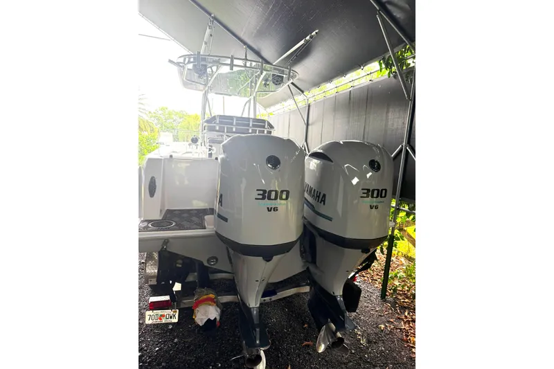 Slide: The Image of 2019 Contender 30 ST boat with twin Yamaha 300 V6 engines under a canopy. - 2