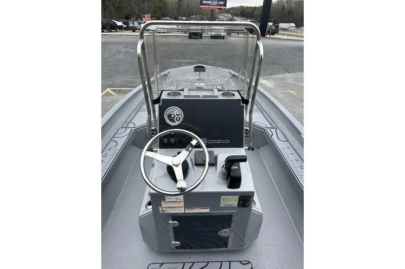 Slide: The Image of 2025 Xpress H22B Bay boat console with steering wheel and controls. - 13