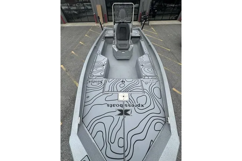 Slide: The Image of 2025 Xpress H22B Bay boat with sleek design and modern features, parked outdoors. - 14