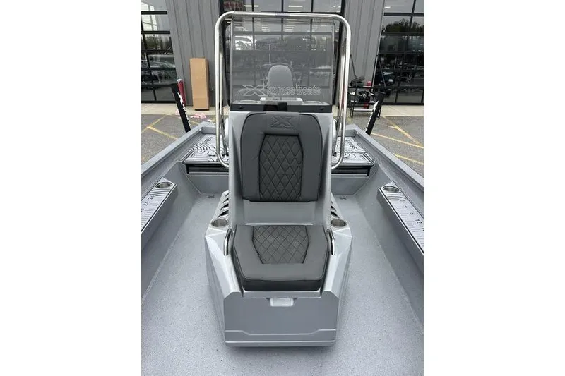 Slide: The Image of 2025 Xpress H22B Bay boat interior with gray seating and console. - 15
