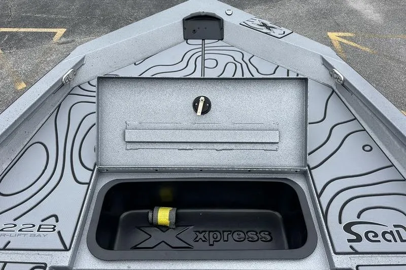 Slide: The Image of 2025 Xpress H22B Bay boat interior with storage compartment and unique design. - 16