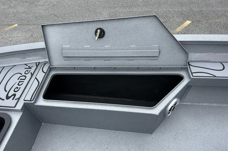 Slide: The Image of 2025 Xpress H22B Bay boat storage compartment with SeaDek flooring. - 2