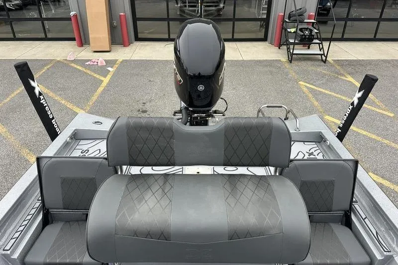 Slide: The Image of 2025 Xpress H22B Bay boat with gray seating and powerful outboard motor. - 3