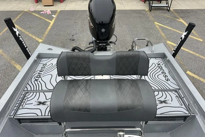Slide: The Image of 2025 Xpress H22B Bay boat interior with dual seats and motor, showcasing sleek design. - 5