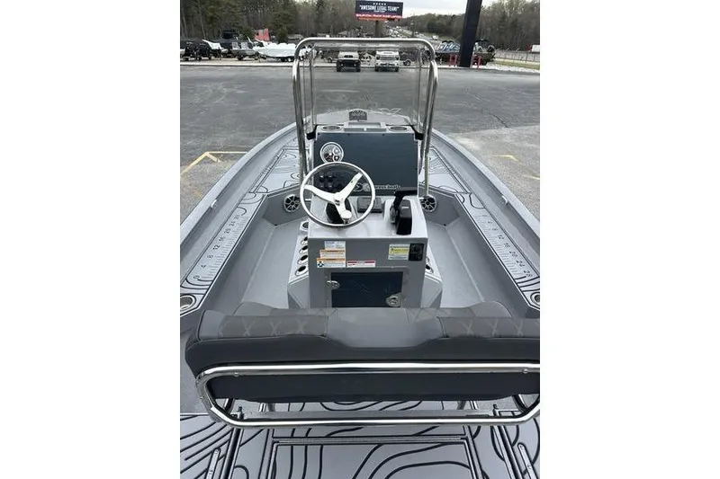 Slide: The Image of 2025 Xpress H22B Bay boat interior with steering console and seating. - 8