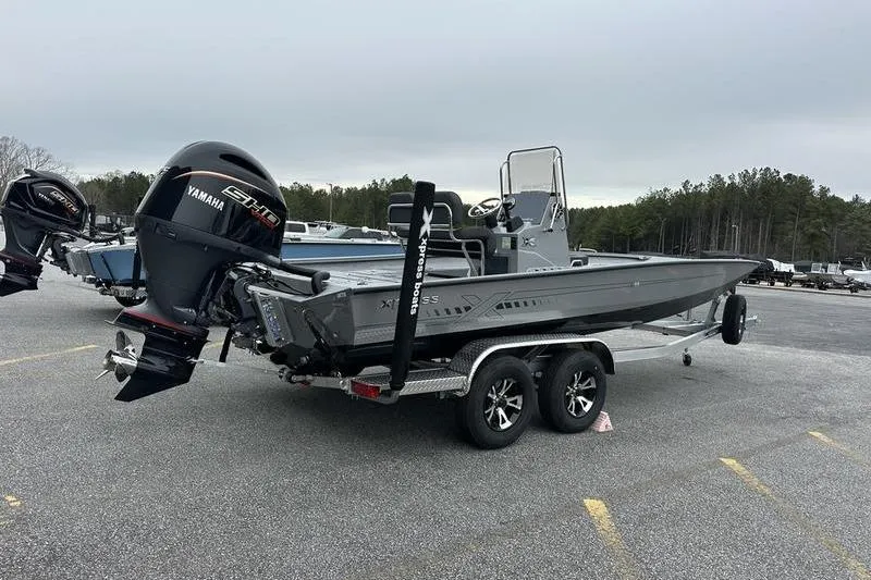 Slide: The Image of 2025 Xpress H22B Bay boat with Yamaha engine on trailer in parking lot. - 9