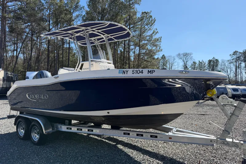 Slide: The Image of 2019 Robalo R200 Center Console boat on trailer, parked outdoors. - 3