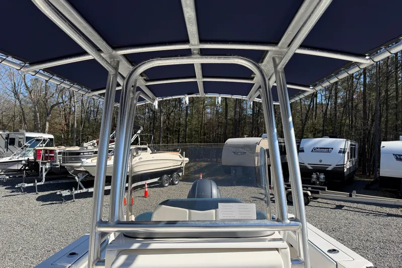 Slide: The Image of 2019 Robalo R200 Center Console boat with T-top in a storage yard. - 7