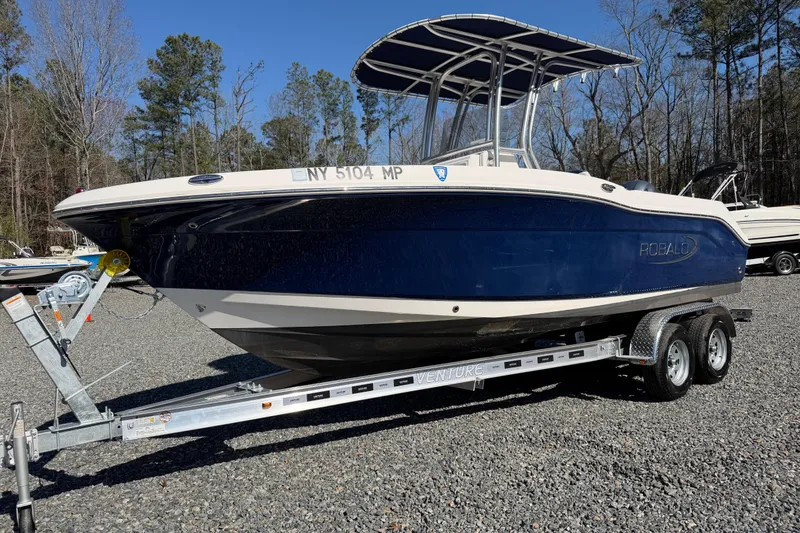 Slide: The Image of 2019 Robalo R200 Center Console boat on trailer, parked outdoors. - 8