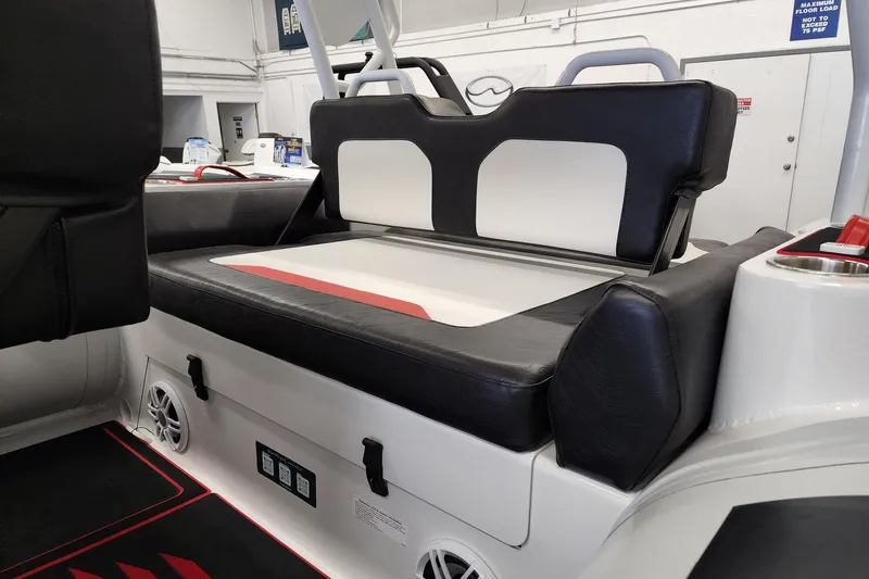 Slide: The Image of 2026 Highfield Velox 560 boat interior with black and white seating, cup holders, and speakers. - 11