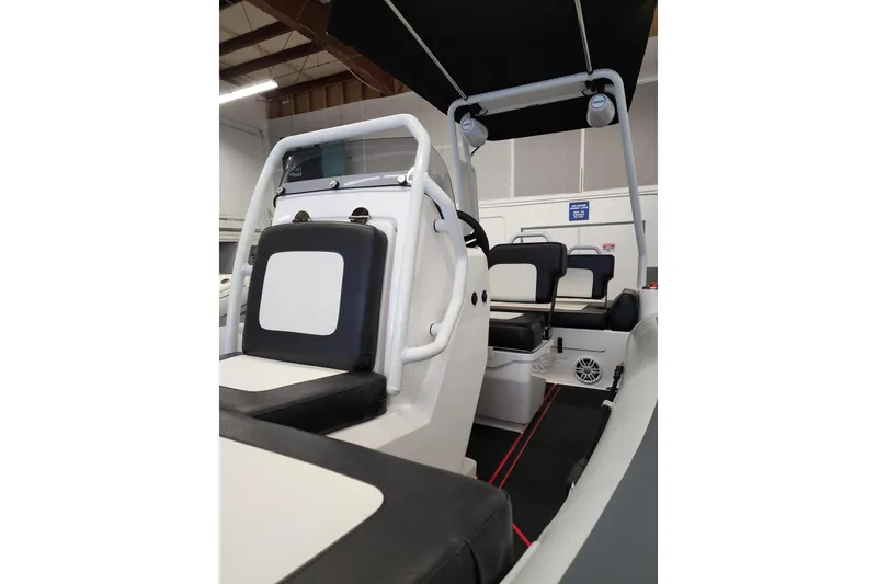 Slide: The Image of 2026 Highfield Velox 560 boat interior with seating and steering console. - 15
