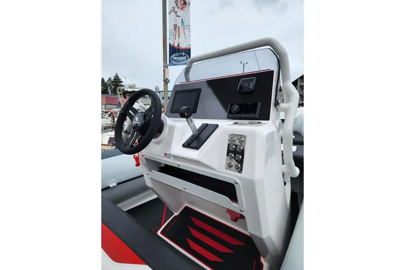 Slide: The Image of 2026 Highfield Velox 560 boat console with steering wheel and control panel. - 9
