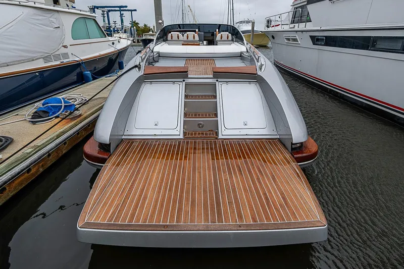 Slide: The Image of 2020 Riva 38' Rivamare luxury yacht docked, showcasing elegant wooden deck design. - 4