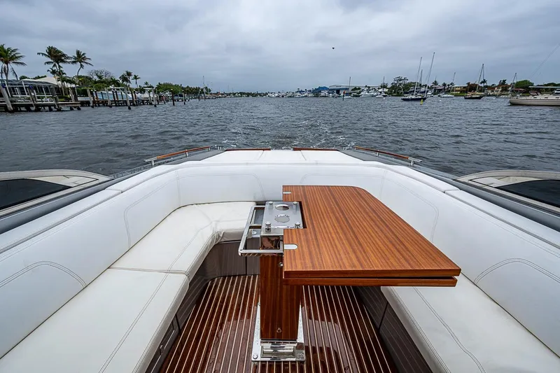 Slide: The Image of Luxurious 2020 Riva 38' Rivamare yacht interior with wooden table and white seating. - 7