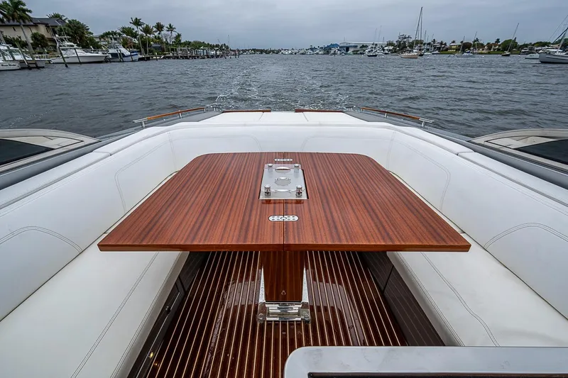 Slide: The Image of Luxurious 2020 Riva 38' Rivamare yacht with elegant wooden table and white seating. - 8