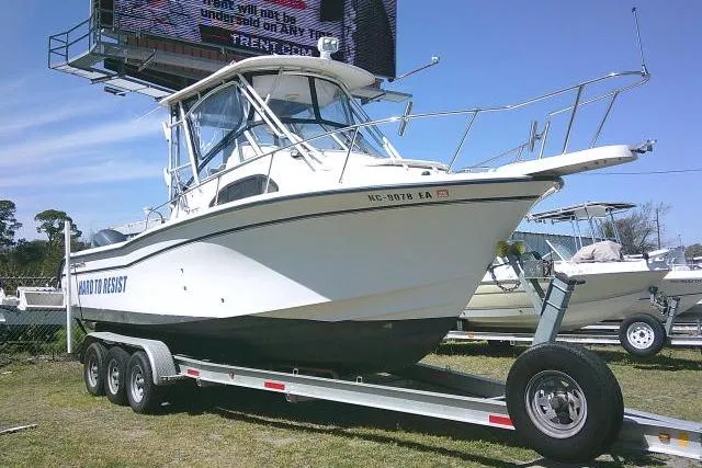 The Image of 2004 Grady White 27 Islander boat on trailer, displayed outdoors. - 0