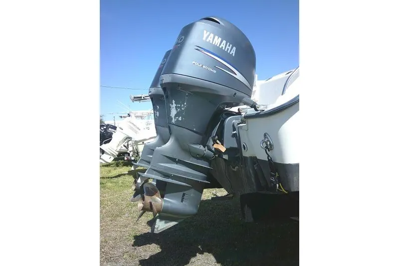 Slide: The Image of Yamaha outboard motor on 2004 Grady White 27 Islander boat, parked on grass. - 12