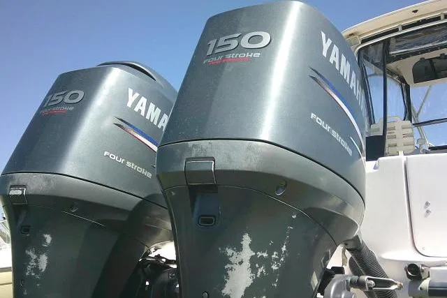 Slide: The Image of Twin Yamaha 150 four-stroke engines on a 2004 Grady White 27 Islander boat. - 14