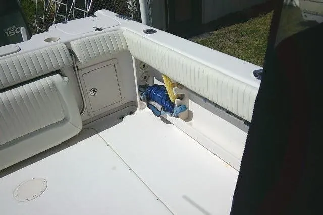 Slide: The Image of 2004 Grady White 27 Islander boat interior with white seating and storage compartment. - 19