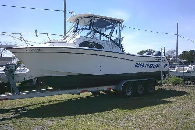 Slide: The Image of 2004 Grady White 27 Islander boat on trailer, side view, outdoors. - 2