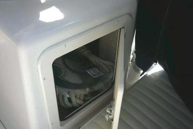 Slide: The Image of Storage compartment on a 2004 Grady White 27 Islander boat with rope inside. - 30