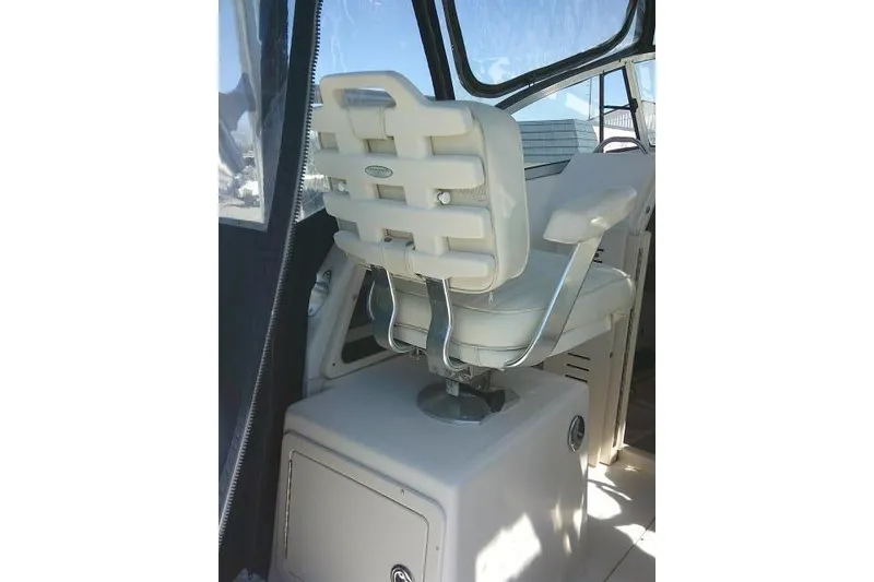 Slide: The Image of Captain's chair on 2004 Grady White 27 Islander boat, featuring a sleek design. - 33