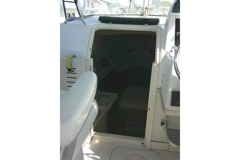 Slide: The Image of 2004 Grady White 27 Islander cabin entrance with seating and helm details. - 34