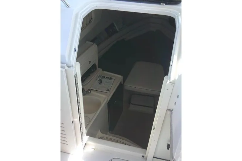 Slide: The Image of Interior cabin of 2004 Grady White 27 Islander boat, featuring compact amenities. - 41