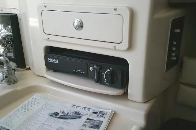 Slide: The Image of 2004 Grady White 27 Islander cabin interior with built-in appliances and control panel. - 48