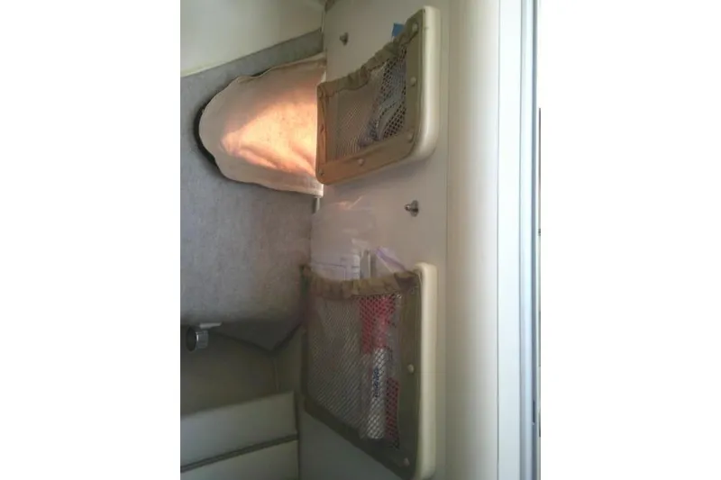 Slide: The Image of Interior cabin storage of 2004 Grady White 27 Islander boat with mesh pockets. - 50