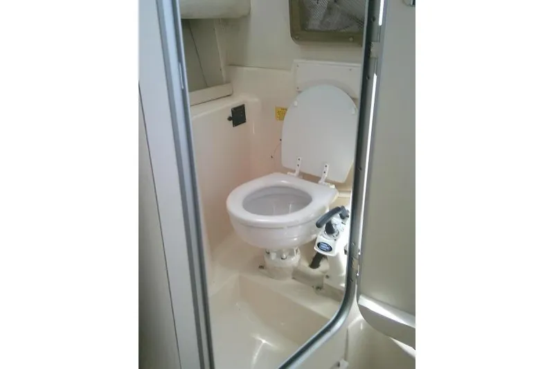 Slide: The Image of 2004 Grady White 27 Islander boat bathroom interior with toilet. - 51