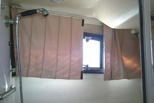 Slide: The Image of Interior of 2004 Grady White 27 Islander boat with shower and curtains. - 53