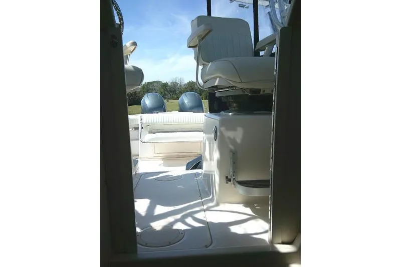 Slide: The Image of 2004 Grady White 27 Islander boat interior with seating and clear sky background. - 54