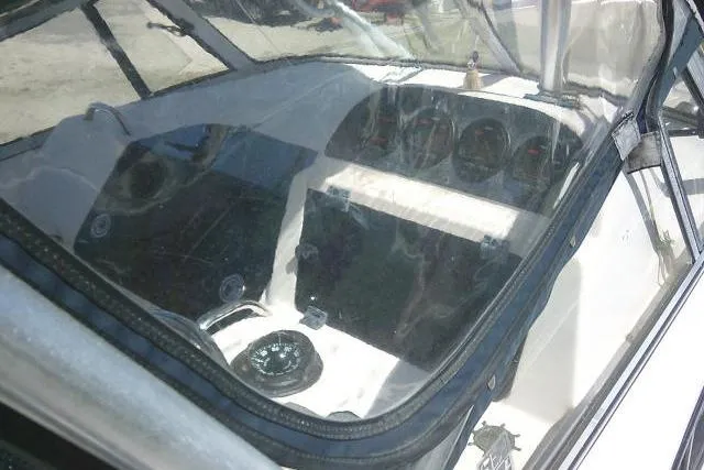 Slide: The Image of 2004 Grady White 27 Islander boat cockpit with steering wheel and instrument panel. - 57