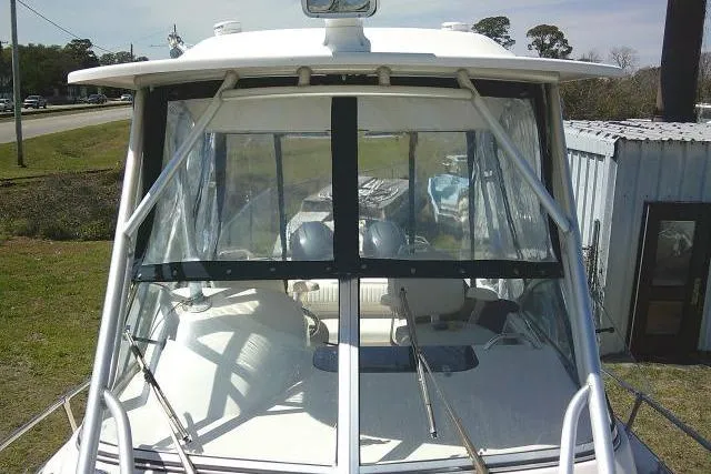 Slide: The Image of 2004 Grady White 27 Islander boat with clear windshield and outdoor setting. - 61