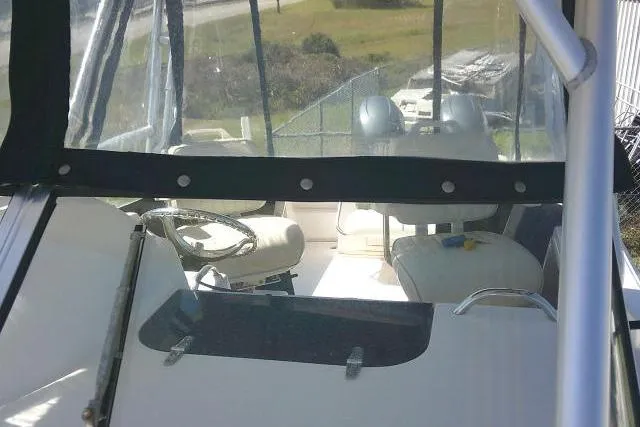 Slide: The Image of 2004 Grady White 27 Islander boat interior with steering wheel and seating. - 62