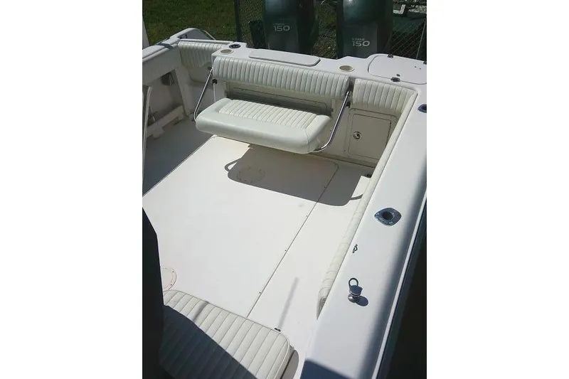 Slide: The Image of 2004 Grady White 27 Islander boat interior with seating and storage compartments. - 63
