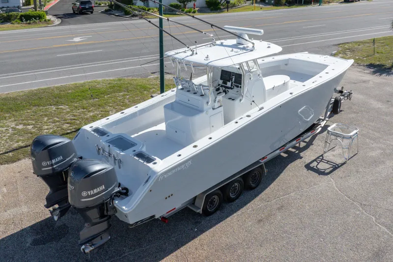 Slide: The Image of 2014 Freeman 33 boat with dual Yamaha engines on a trailer. - 11