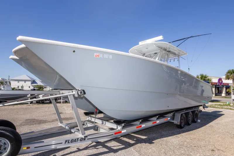 Slide: The Image of 2014 Freeman 33 boat on trailer under clear blue sky. - 15