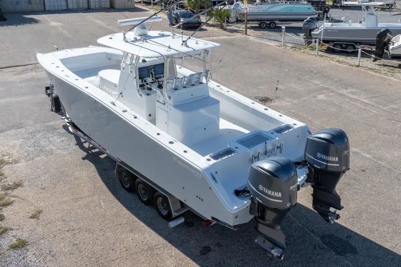 Slide: The Image of 2014 Freeman 33 boat with dual Yamaha engines on a trailer. - 18