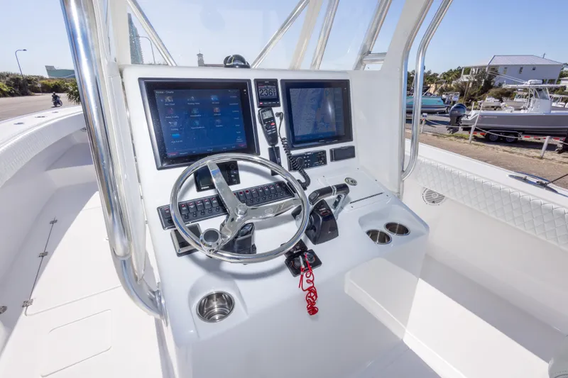 Slide: The Image of Control console of a 2014 Freeman 33 boat with dual screens and steering wheel. - 23