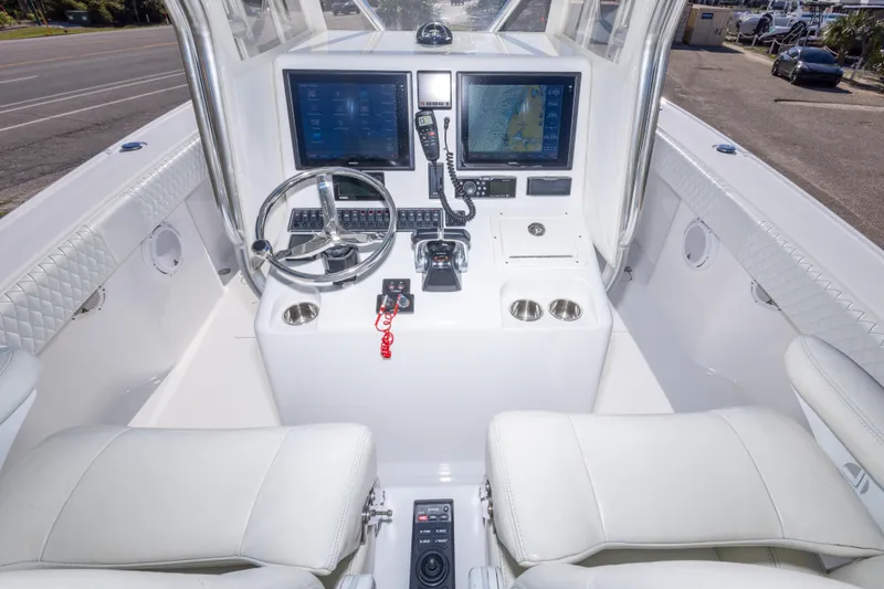 Slide: The Image of Cockpit of a 2014 Freeman 33 boat with modern navigation equipment and steering wheel. - 24