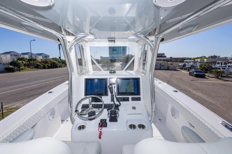 Slide: The Image of Interior view of a 2014 Freeman 33 boat cockpit with navigation screens and steering wheel. - 25