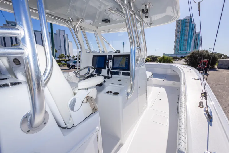 Slide: The Image of 2014 Freeman 33 boat cockpit with modern navigation equipment and sleek white design. - 26