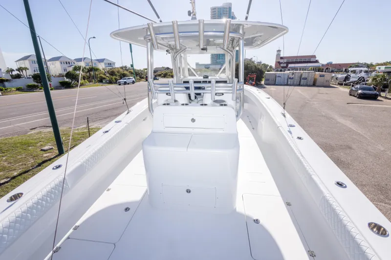 Slide: The Image of 2014 Freeman 33 boat with spacious deck and modern design, parked near a coastal road. - 28