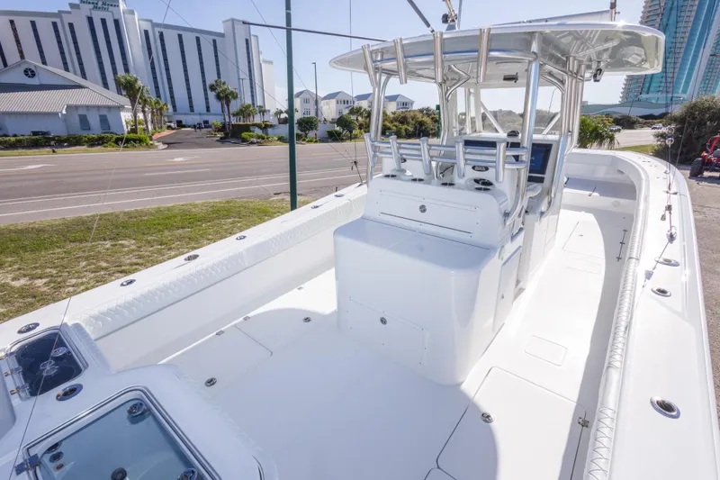Slide: The Image of Freeman 33 boat, 2014 model, docked near a hotel, showcasing spacious deck and helm. - 29